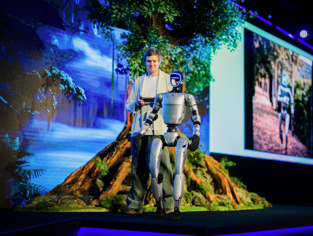 Perry Nightingale, SVP of Creative AI at WPP, with a humanoid robot named Oracle.